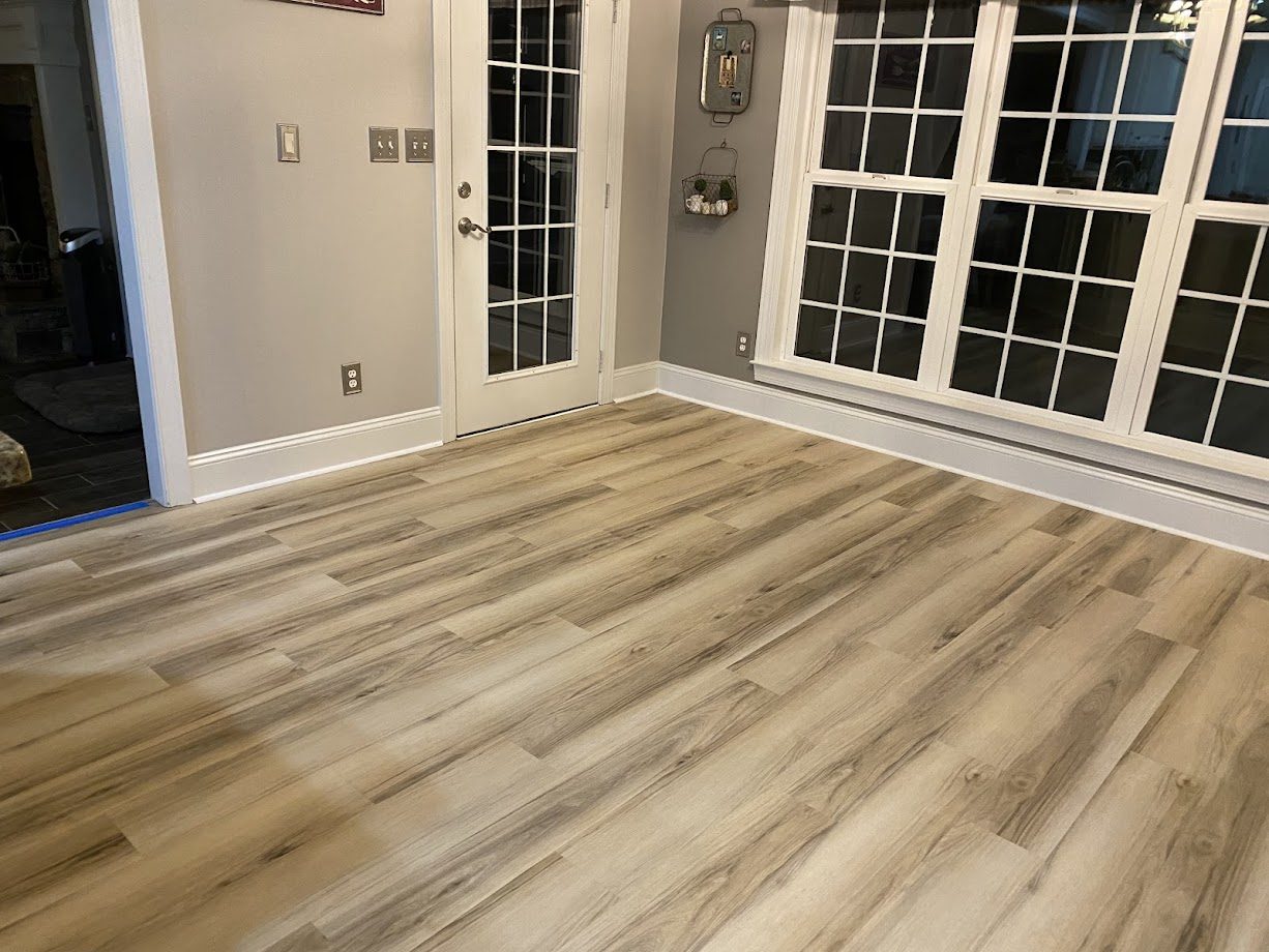 Light oak-look luxury vinyl plank in a bright entryway