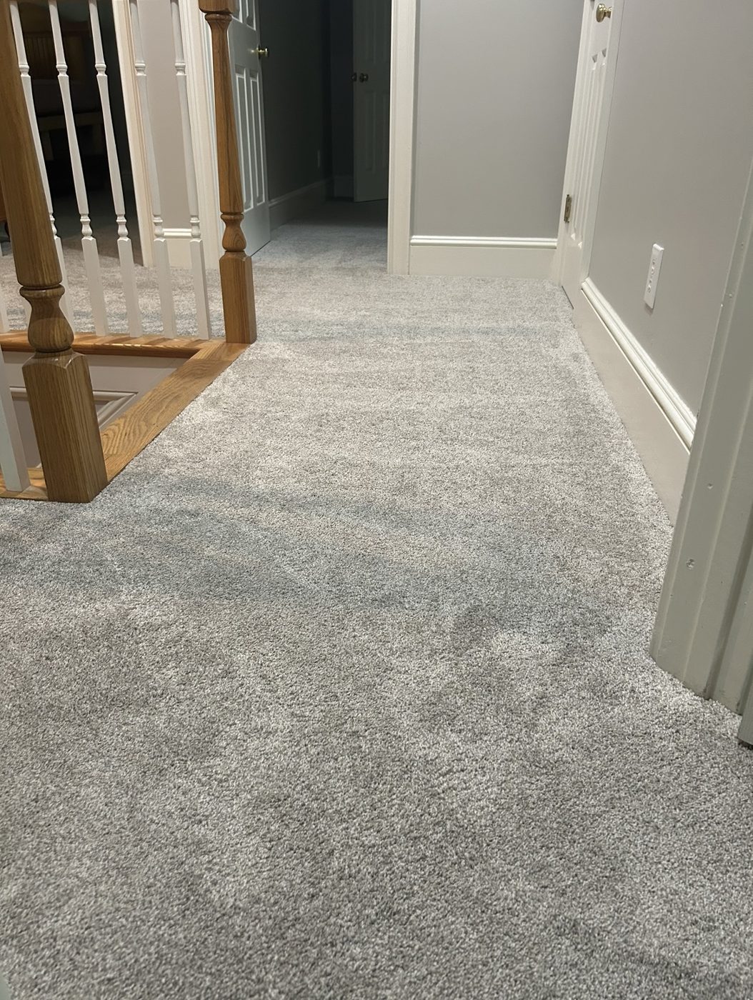 Plush gray carpet installed in an upstairs hallway