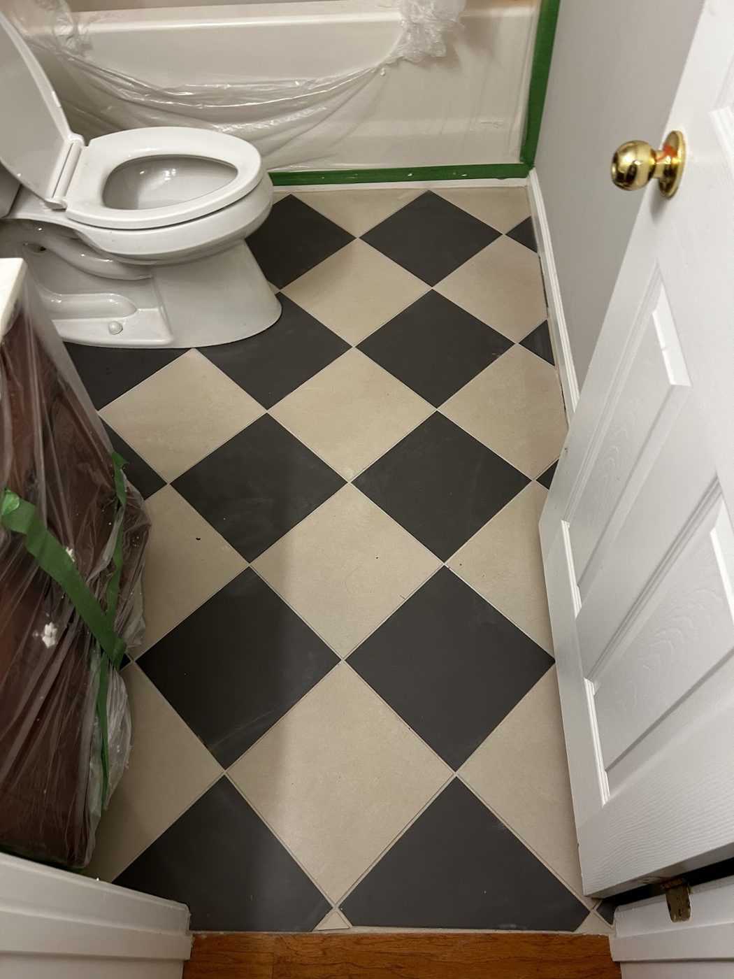 Black-and-white checkered tile floor in an entry bath