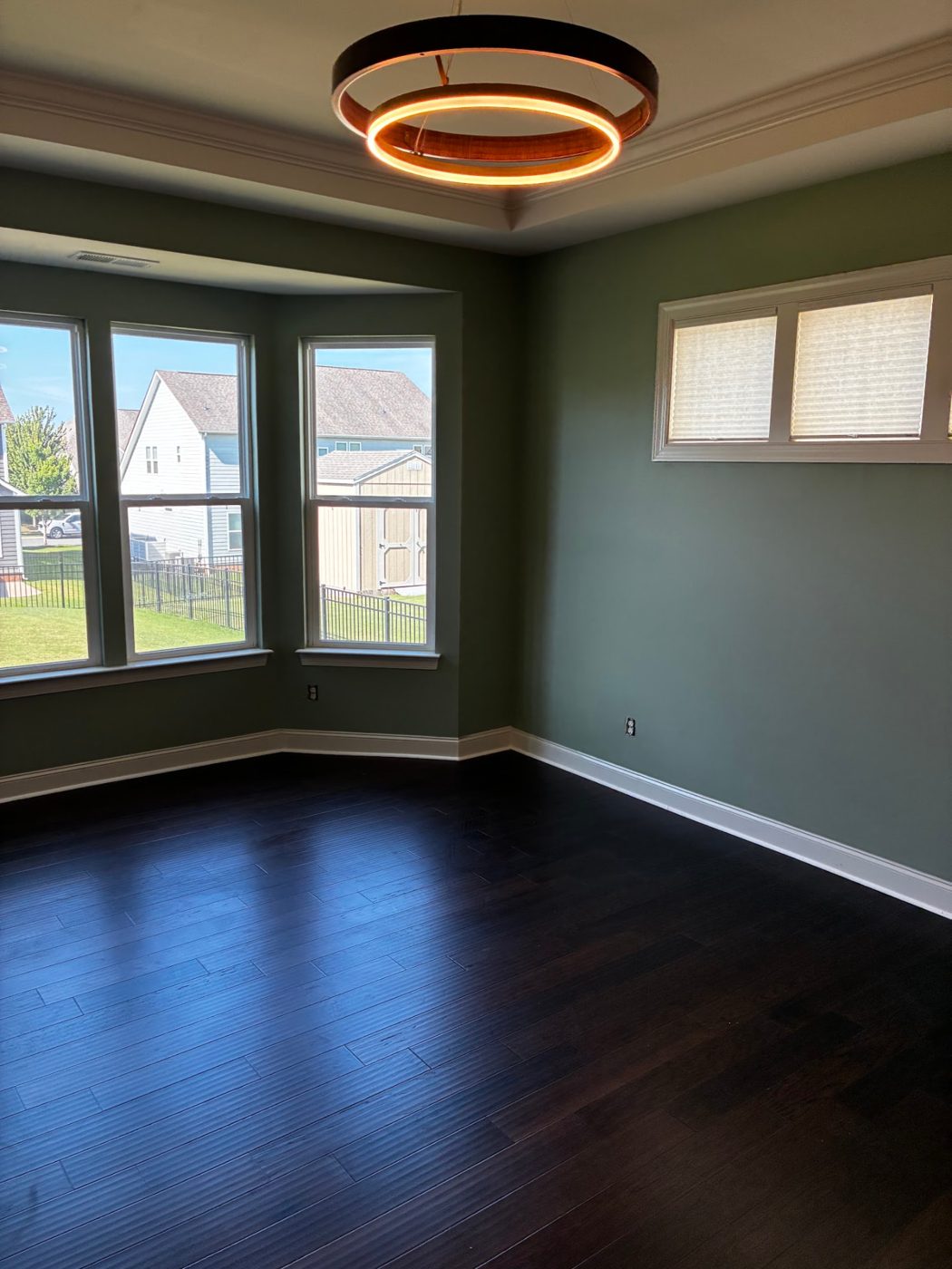 Dining room with dark espresso hardwood flooring and bay windows