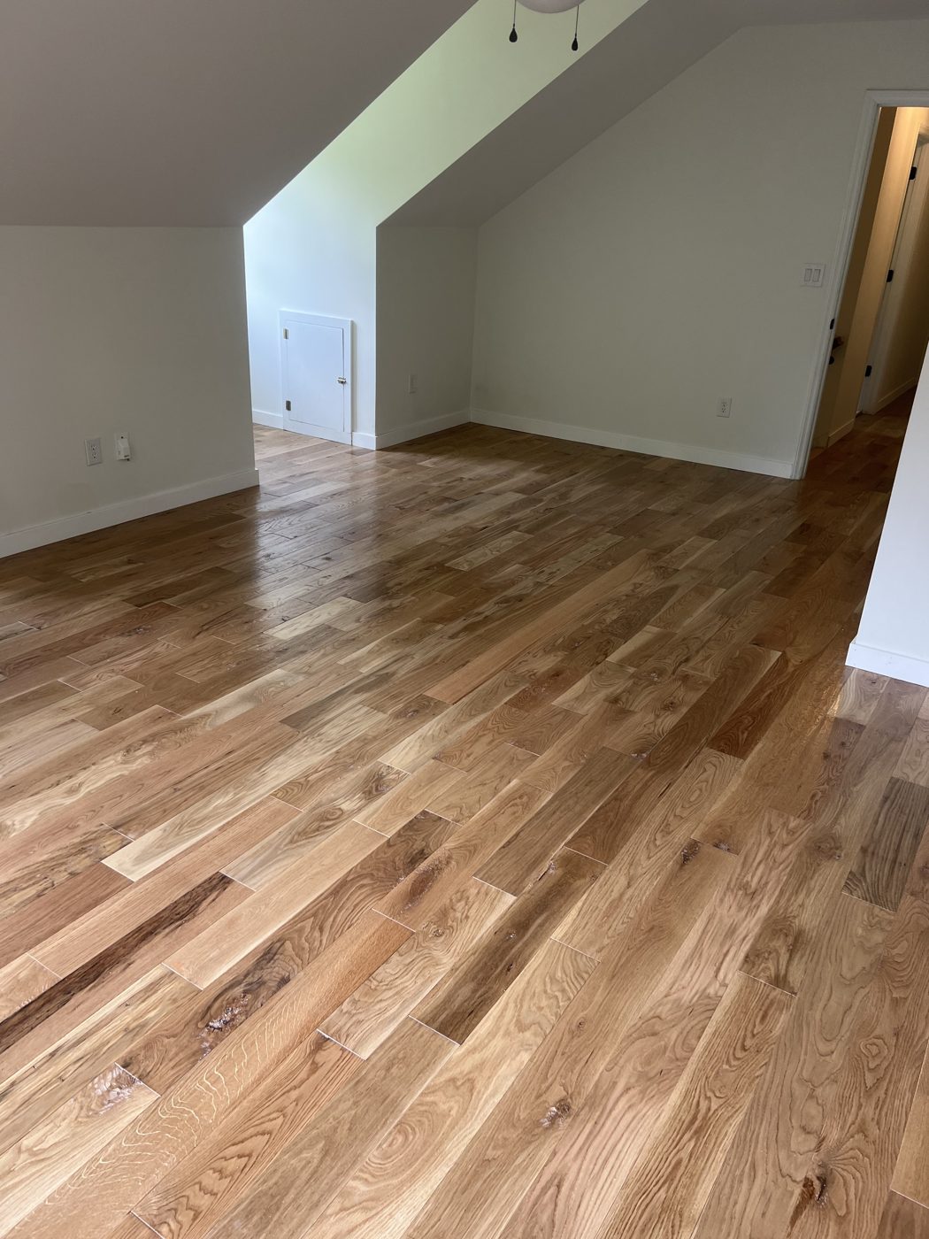 Character-grade hardwood flooring in an upstairs room