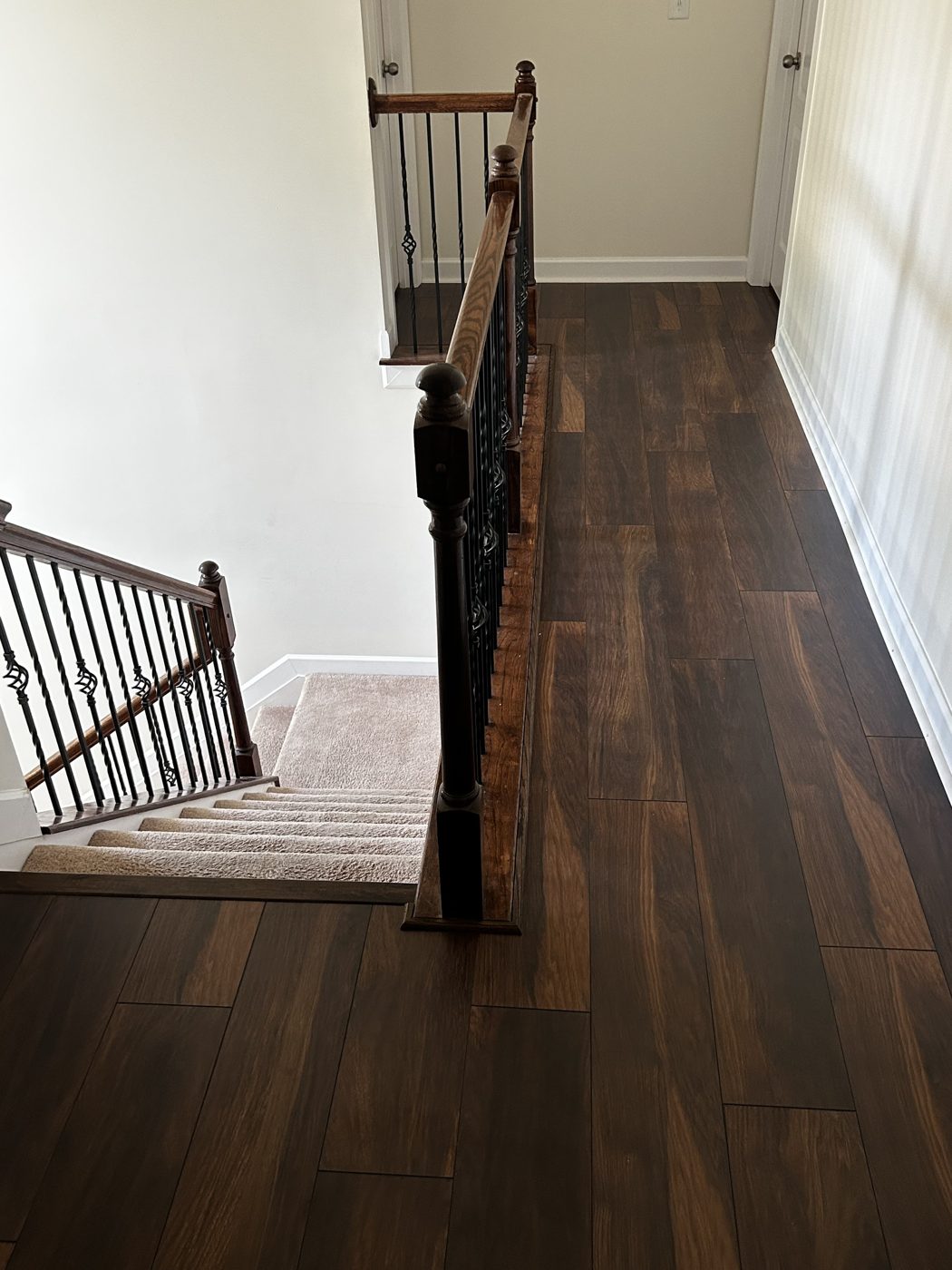 Dark stained hardwood flooring on an upstairs landing