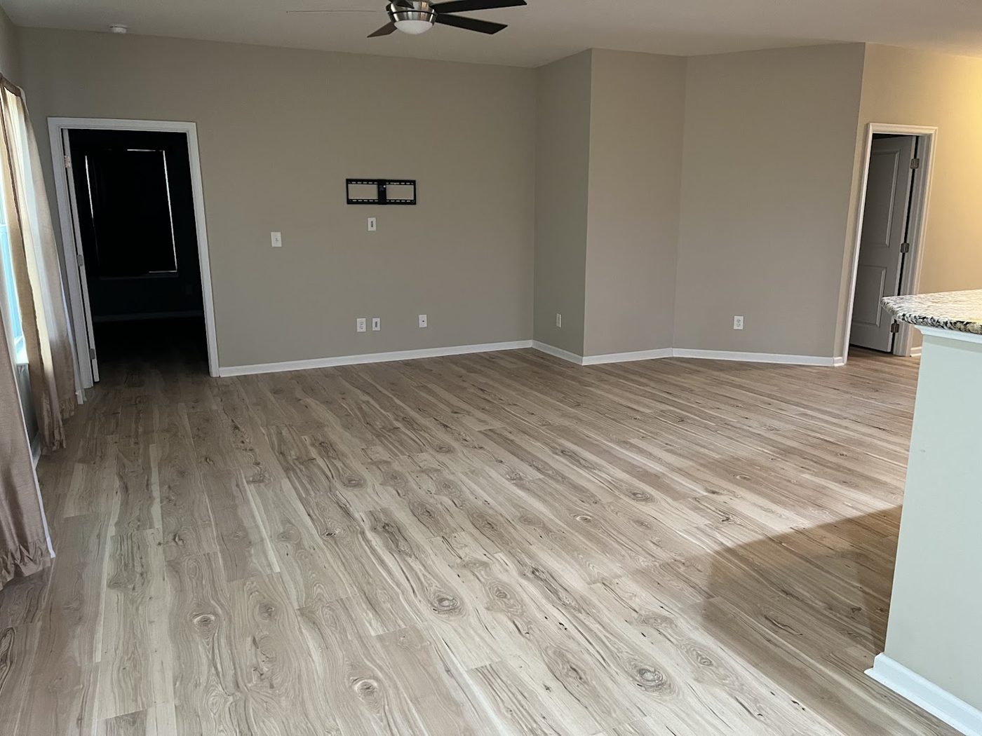 Open living room with light oak luxury vinyl plank flooring