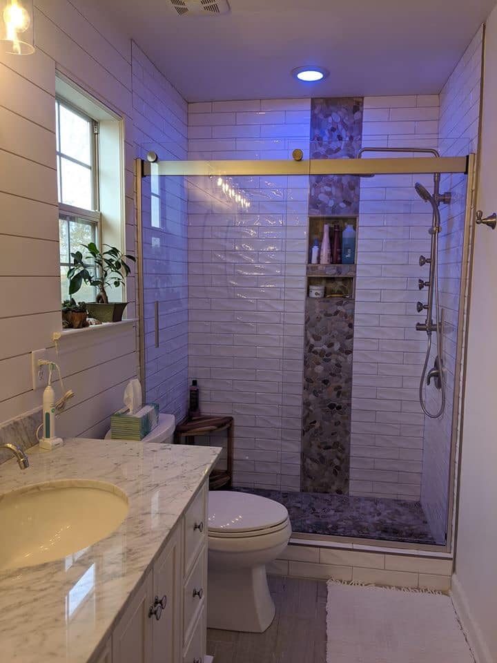 Tiled walk-in shower and bathroom floor in a full remodel