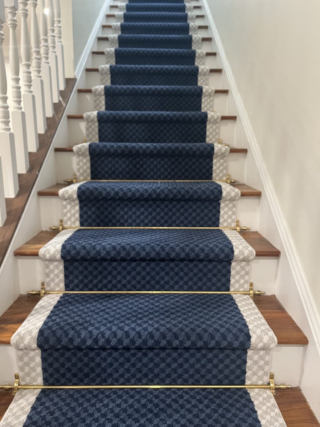 Patterned navy stair runner over painted stair treads