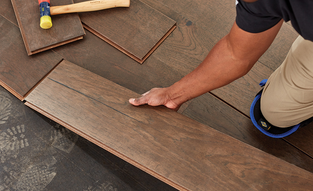 Installer laying wood-look planks in a the Charlotte Metro Area home